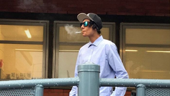 Joshua Leigh Jeffrey smokes a cigarette as he leaves the Burnie Magistrate's Court.