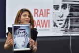 Ensaf Haidar holds a picture of her husband Raif Badawi.