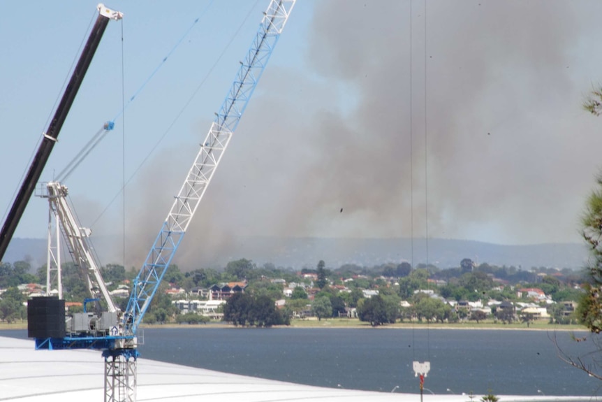 Black smoke clouds fill the sky over Kensington, in Perth's east, where a fire has broken out.