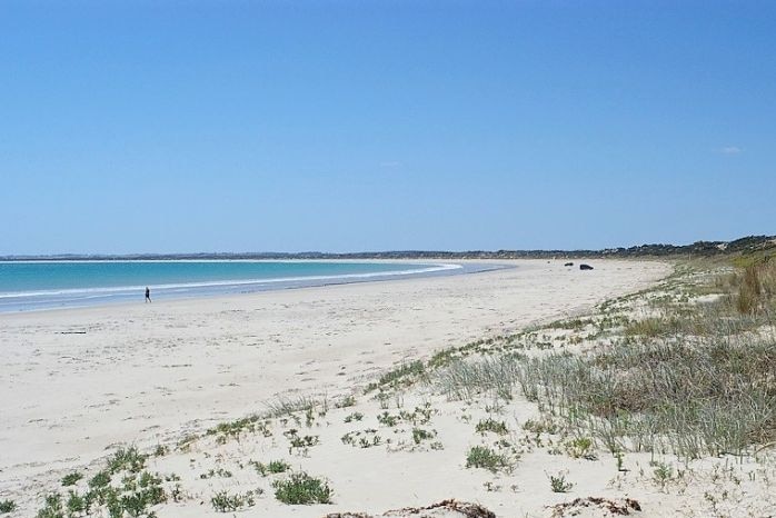 A stunning-looking beach with pale sand on an absolutely corking, clear blue day.