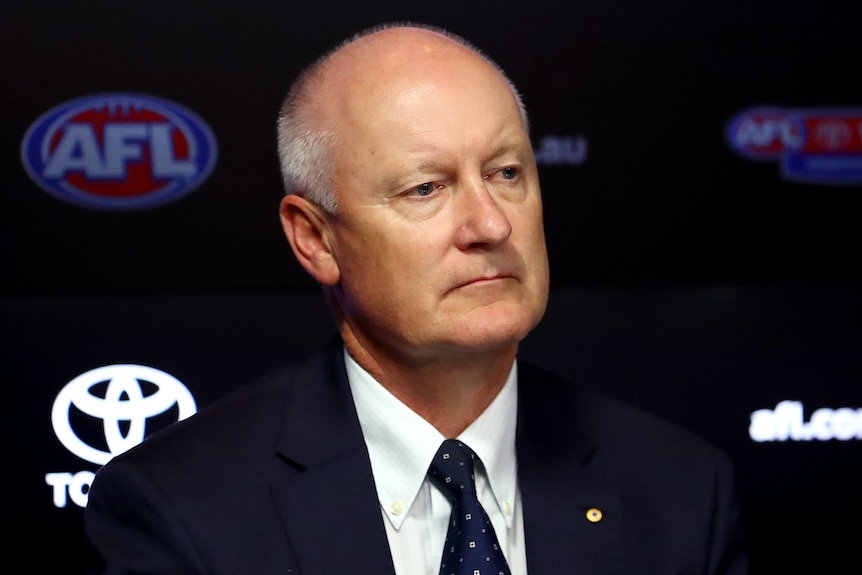 A man at an AFL press conference looks out at the media.