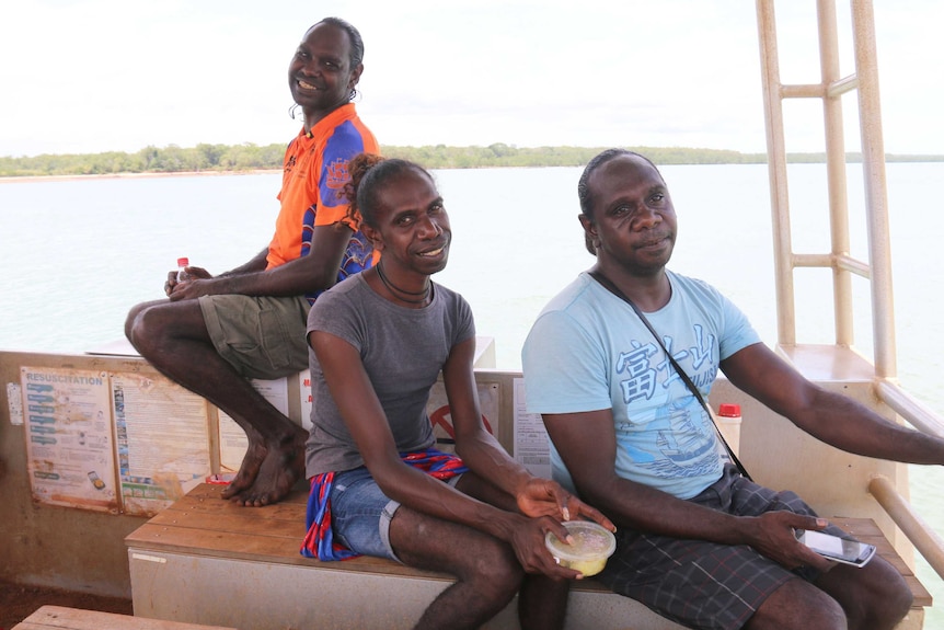 Three trans women cross a strait on a boat