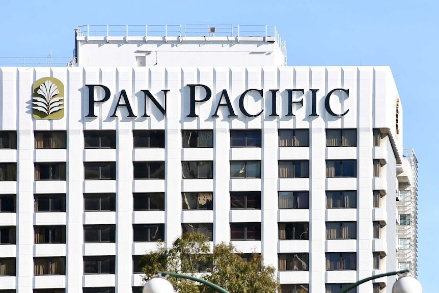 A white hotel with the words Pan Pacific on the side.