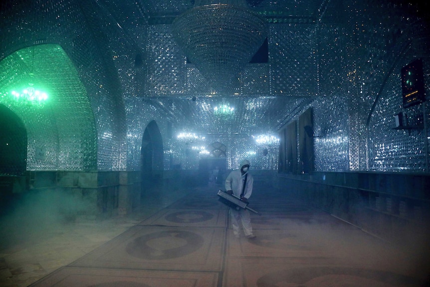 A firefighter disinfects the shrine of Saint Saleh to help prevent the spread of the new coronavirus in northern Tehran.