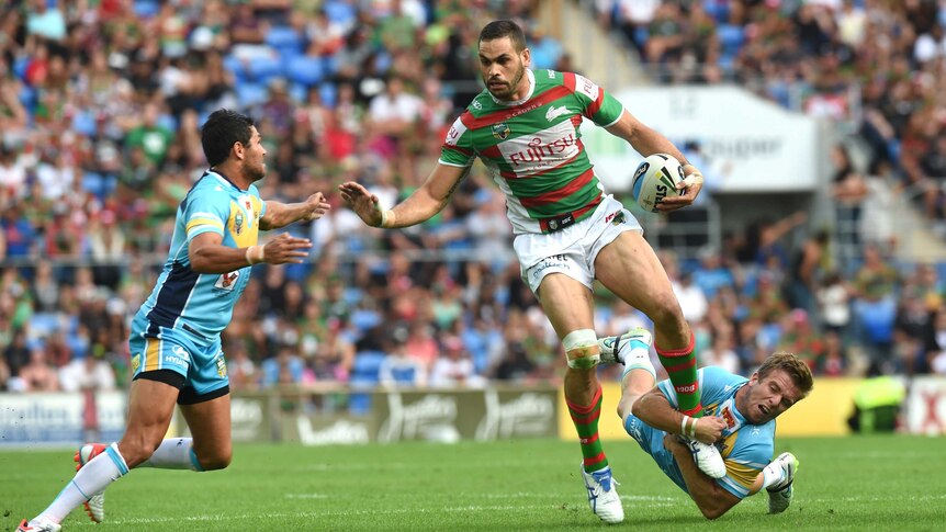 On the charge ... Greg Inglis takes on the Titans defence