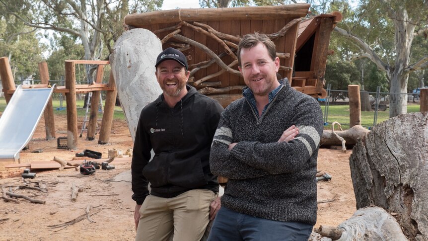 Simon Hutchinson and Peter Semple sit on a log at Morialta playground.