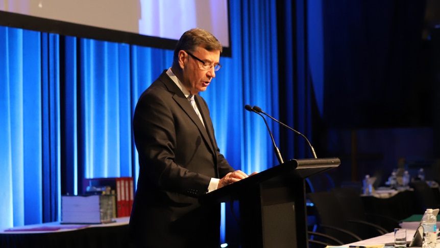 Sydney Anglican Archbishop Glenn Davies speaks at a podium.