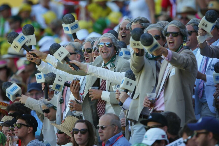 A large group of Richie Benaud impersonators soak in the SCG atmosphere.