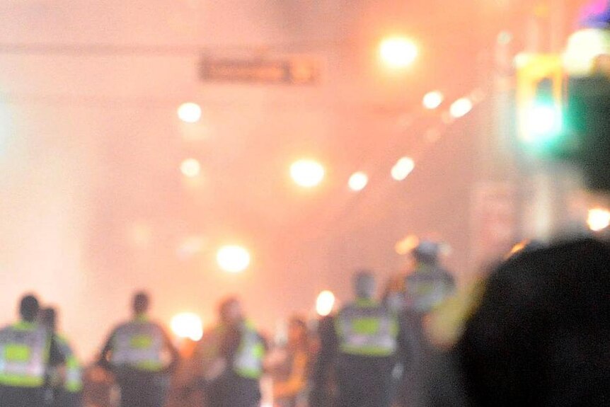 Couple kiss amidst rioting