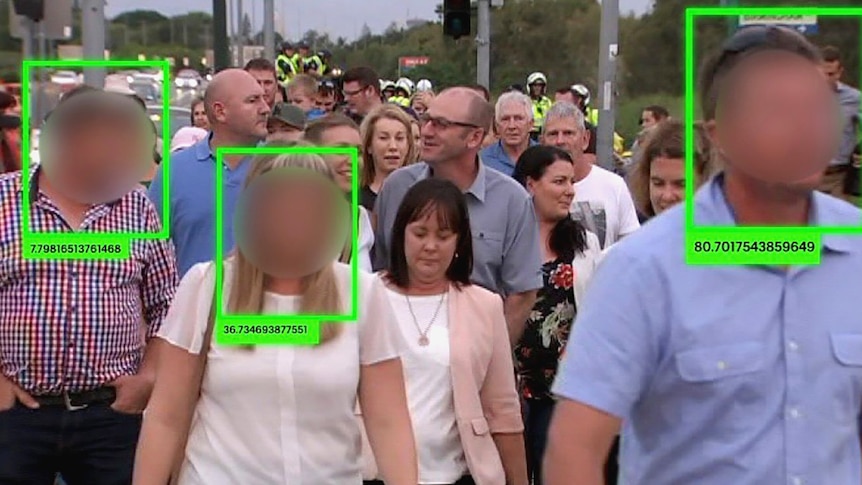 Blurred faces in a crowd with numbered green squares around them