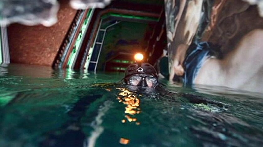 A diver swims inside the submerged Costa Concordia.