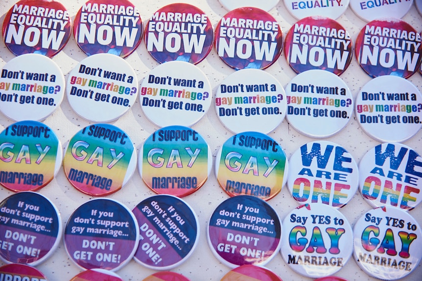 An assortment of colourful badges saying slogans like "marriage equality NOW" and "Say yes to gay marriage".