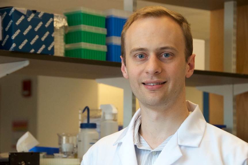 A portrait of a young man in a lab.