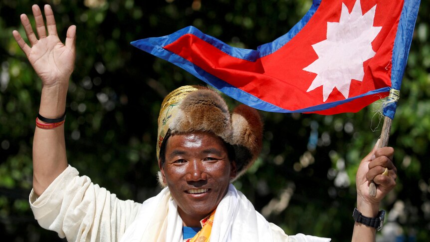 Man waves with Nepali flag.