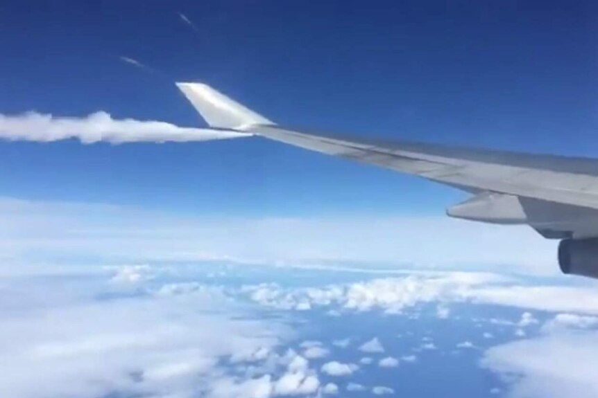 The wing of a plane, with fuel coming out of it.