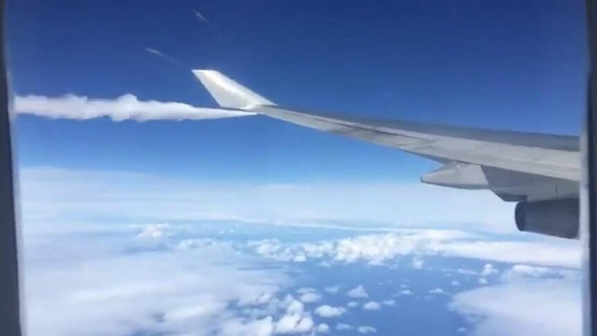 The wing of a plane, with fuel coming out of it.
