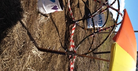 Drums dug into access road at Bentley drilling site