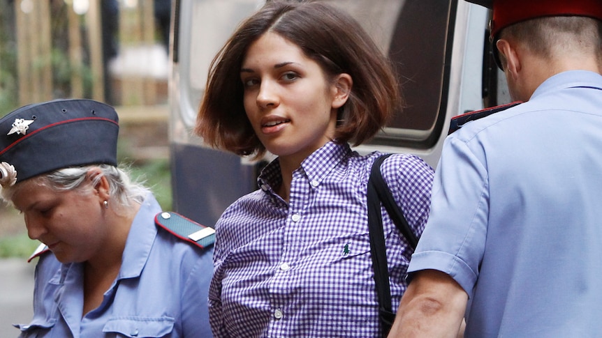 Nadezhda Tolokonnikova, a member of female punk band Pussy Riot, is escorted by police as she arrives at a court in Moscow.