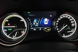 The dashboard of a vehicle showing the speed and odometer of a new car