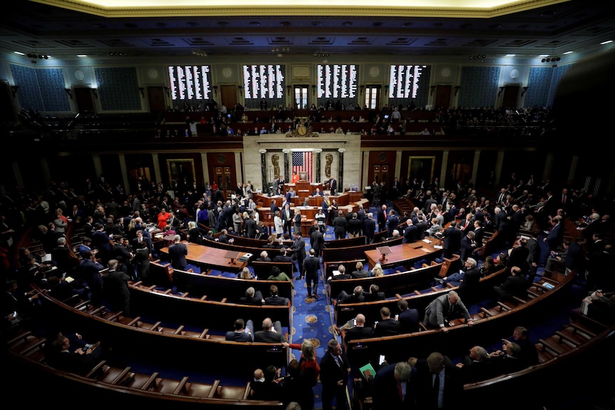 People milling about the US House of Representatives chamber
