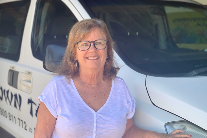 Roslyn Crabb standing in front of a van.