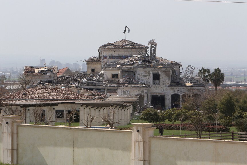 View of a damaged building in the aftermath of missile attacks.