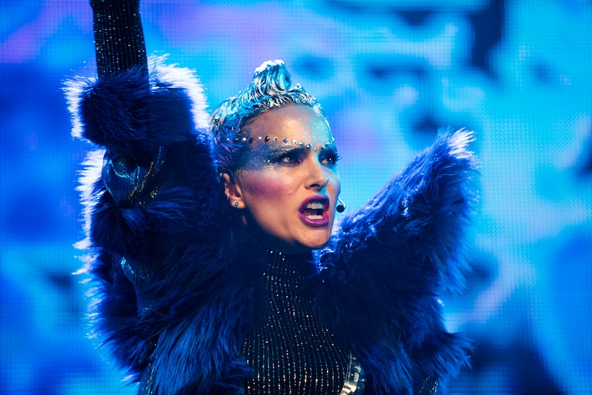 Colour close-up of Natalie Portman performing on stage in 2018 film Vox Lux