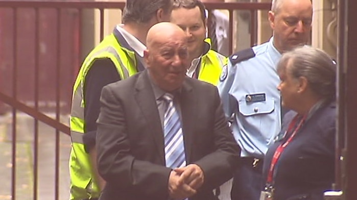 Peter Pavlis is led into the Supreme Court for the plea hearing.