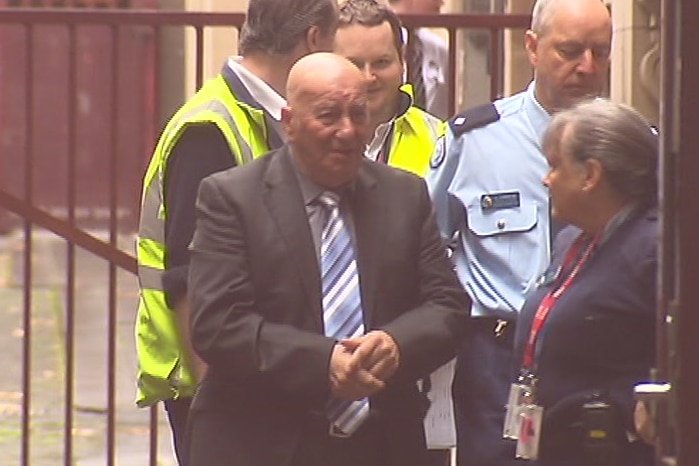 Peter Pavlis is led into the Supreme Court for the plea hearing.