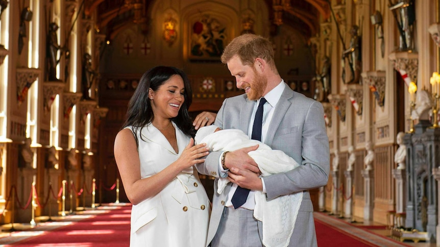 Prince Harry and Meghan, the Duchess of Sussex, with their son in St George's Hall at Windsor Castle.