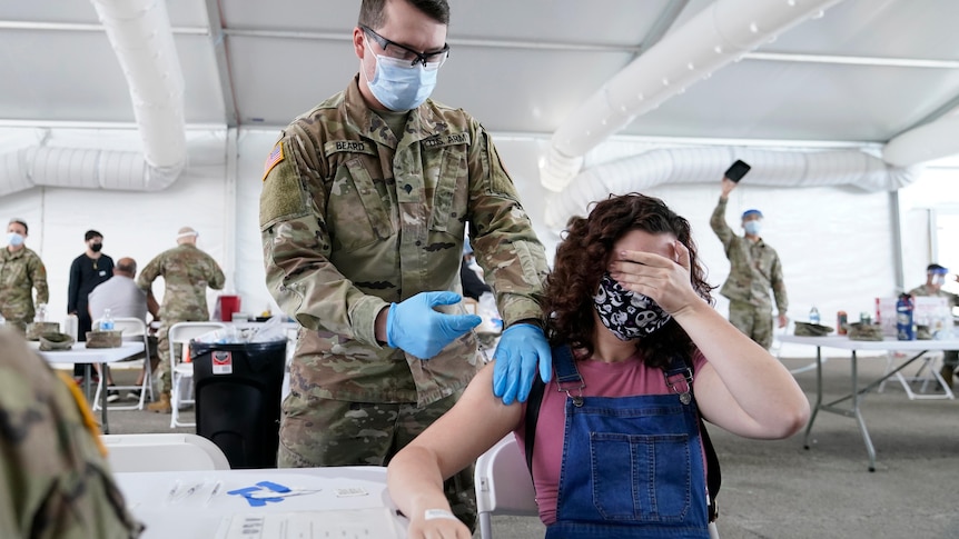 A woman gets a COVID-19 vaccine in Miami