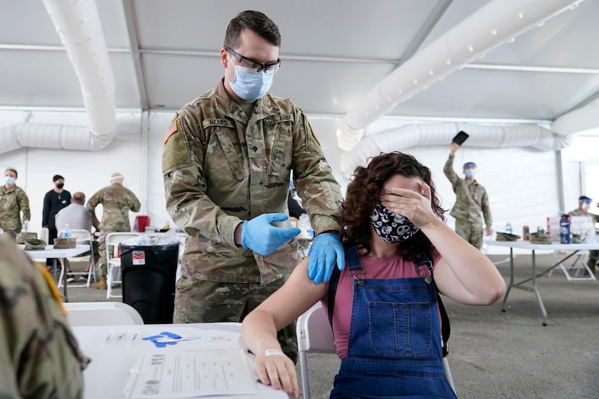 A woman gets a COVID-19 vaccine in Miami