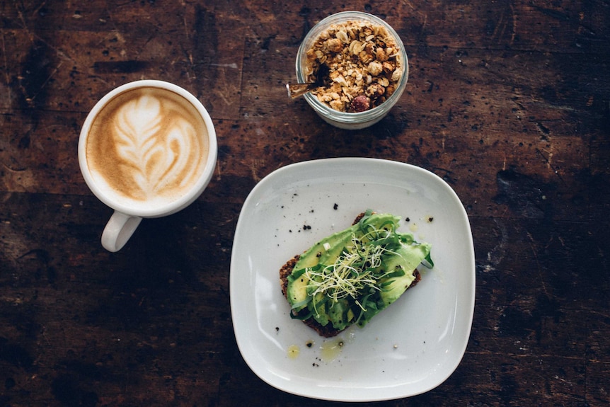 Avocado toast and a coffee on a table.