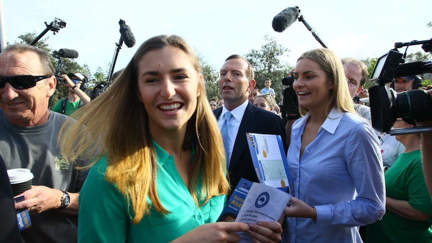Bridget and Frances Abbott hold how-to-vote cards in Tony Abbott's electorate of Warringah