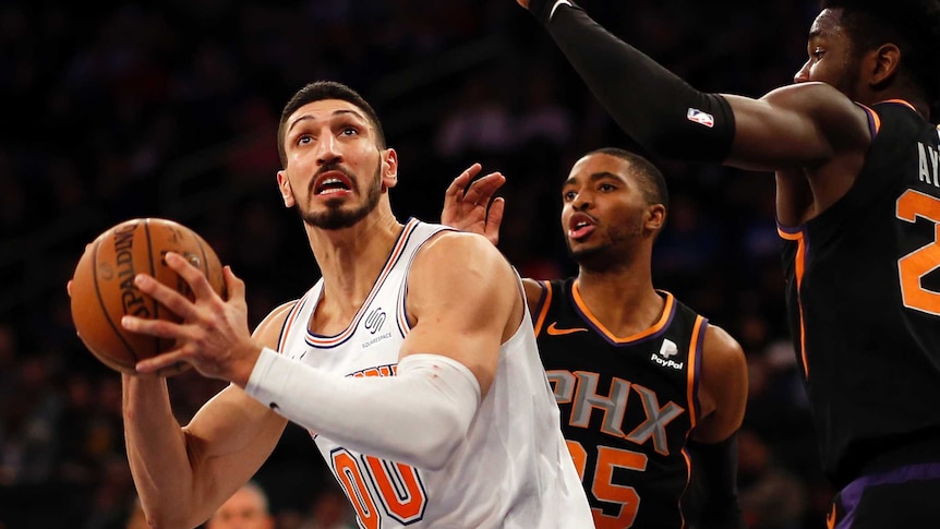 Enes Kanter poises to take a shot as Ayton tries to block