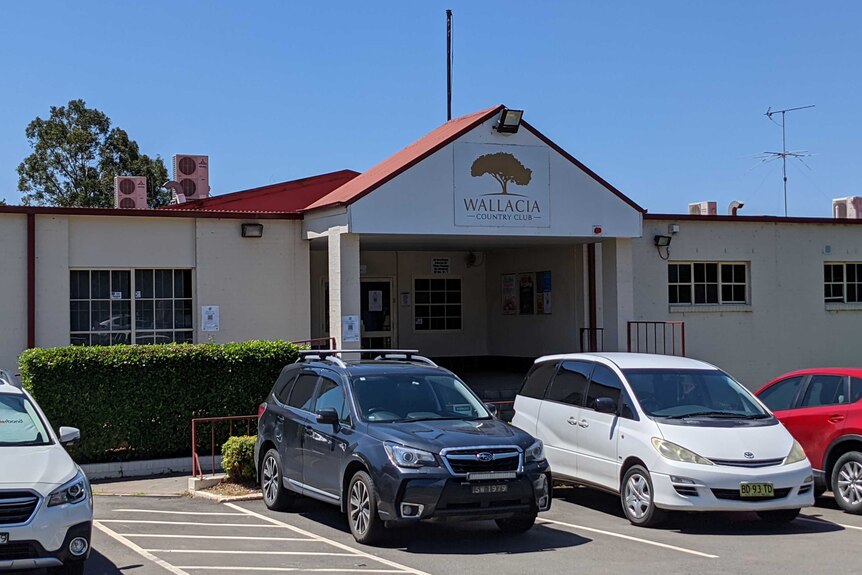 A building with a sign reading Wallacia Country Club.