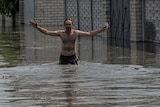 A local resident walks on a flooded street after the Nova Kakhovka dam breached.
