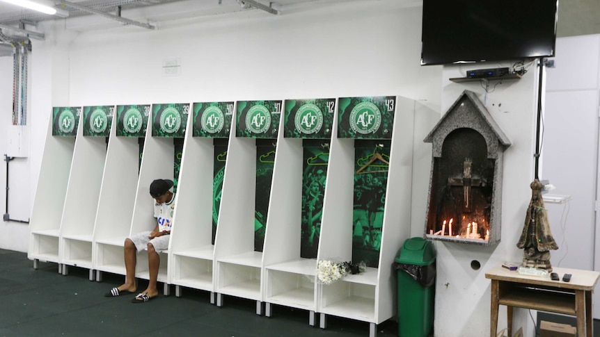 A junior players sits in the Chapecoense dressing room