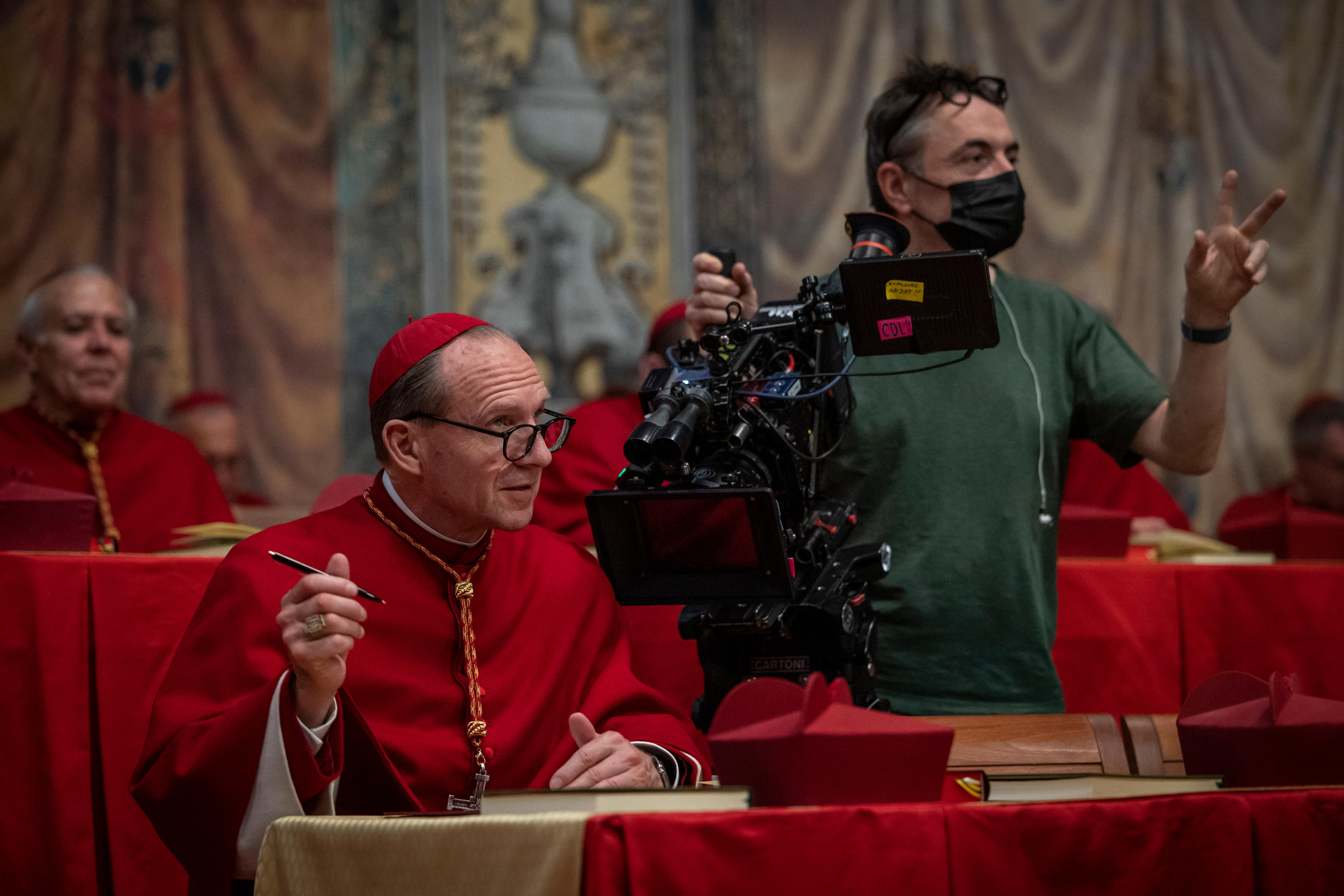 A cameraman with Ralph Fiennes on the set of Conclave.