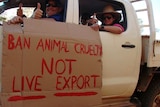 Men in ute with a sign "ban animal cruelty, not live export".