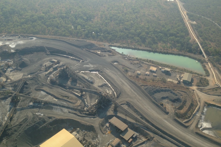 an aerial image of a dark grey mine in the outback