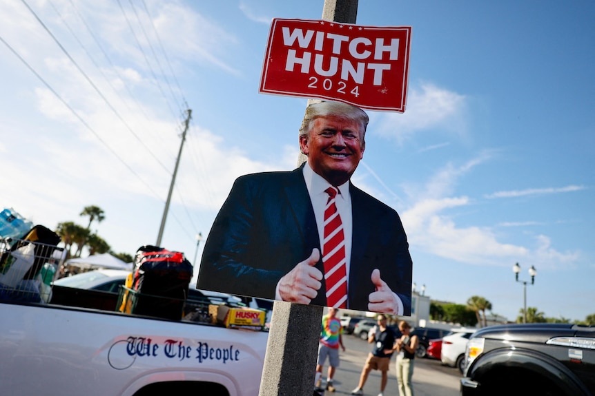 A sign says 'witch hunt' 