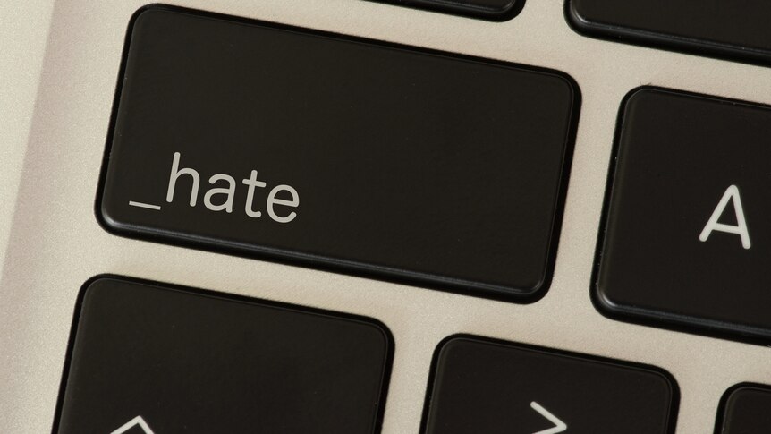 A keyboard with a button saying 'hate' instead of 'Caps'