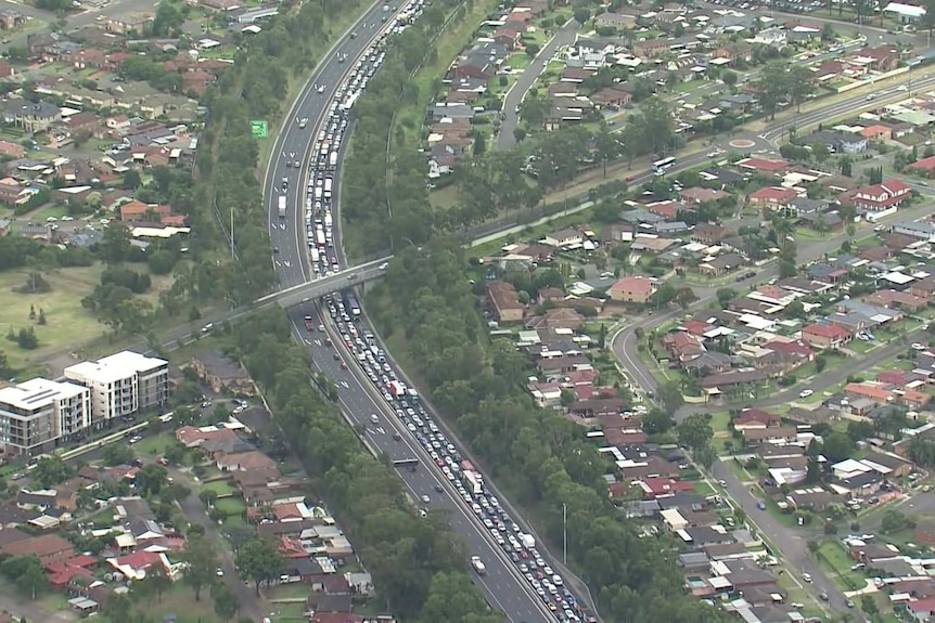 An aerial view of a big traffic jam on a six lane highway in the city.