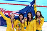 Melanie Schlanger, Alicia Coutts, Brittany Elmslie and Cate Campbell celebrate with gold medals.