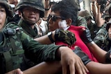 Thai soldiers take away an alleged Red-Shirt protester ahead of a planned gathering in Bangkok.