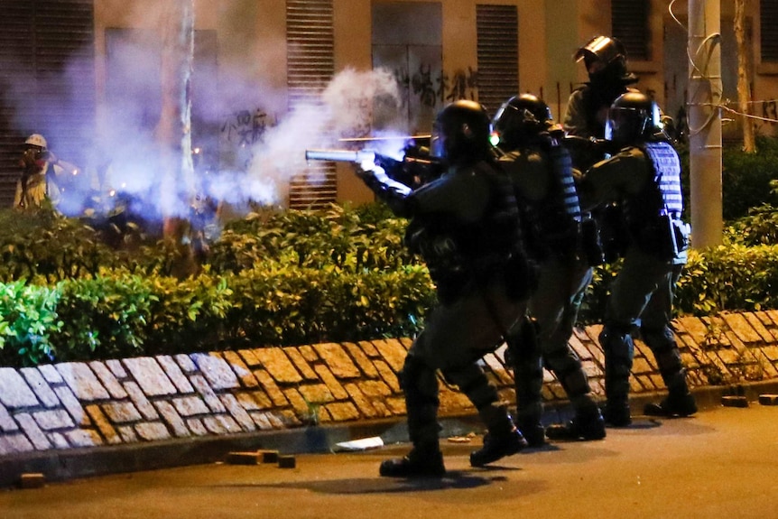 Hong Kong police fire gas rounds at protesters.