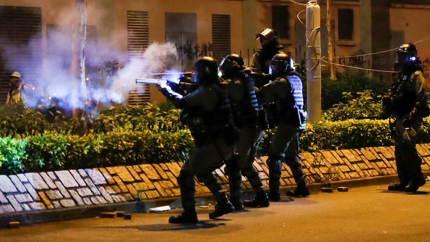 Hong Kong police fire gas rounds at protesters.