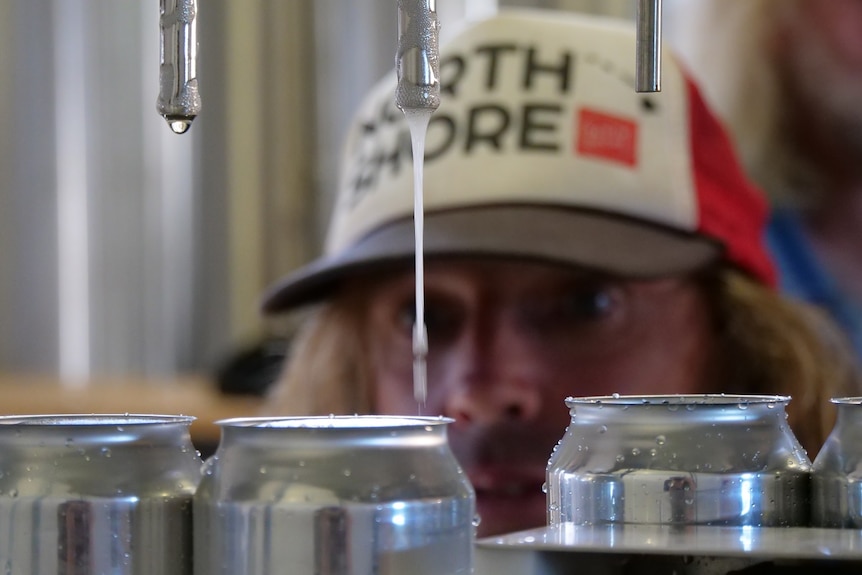 Wayne inspecting a beer being canned.