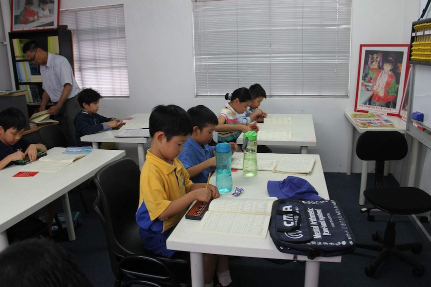 A classroom of young children using the abacus.